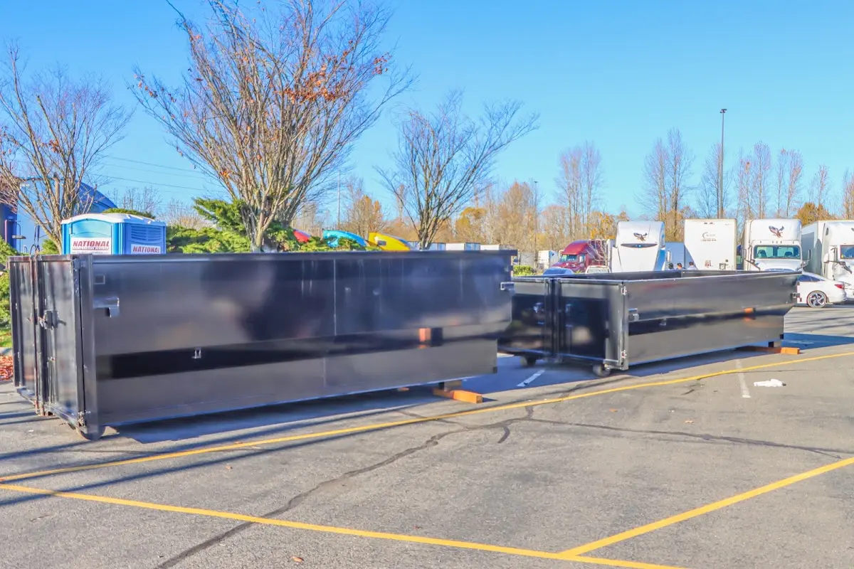 Professional dumpster rental service with roll-off container on residential driveway in Pittsburgh